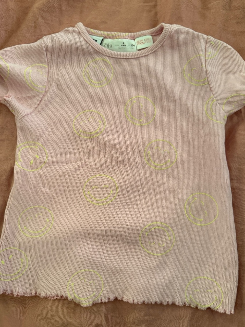 Pink baby tee with yellow smiley face print